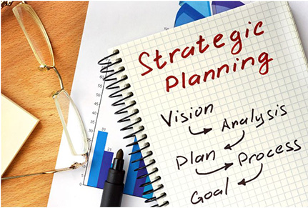 Note book with the words Strategic Planning written in red